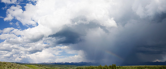 Huge Cumulous Clouds and small Rainbow